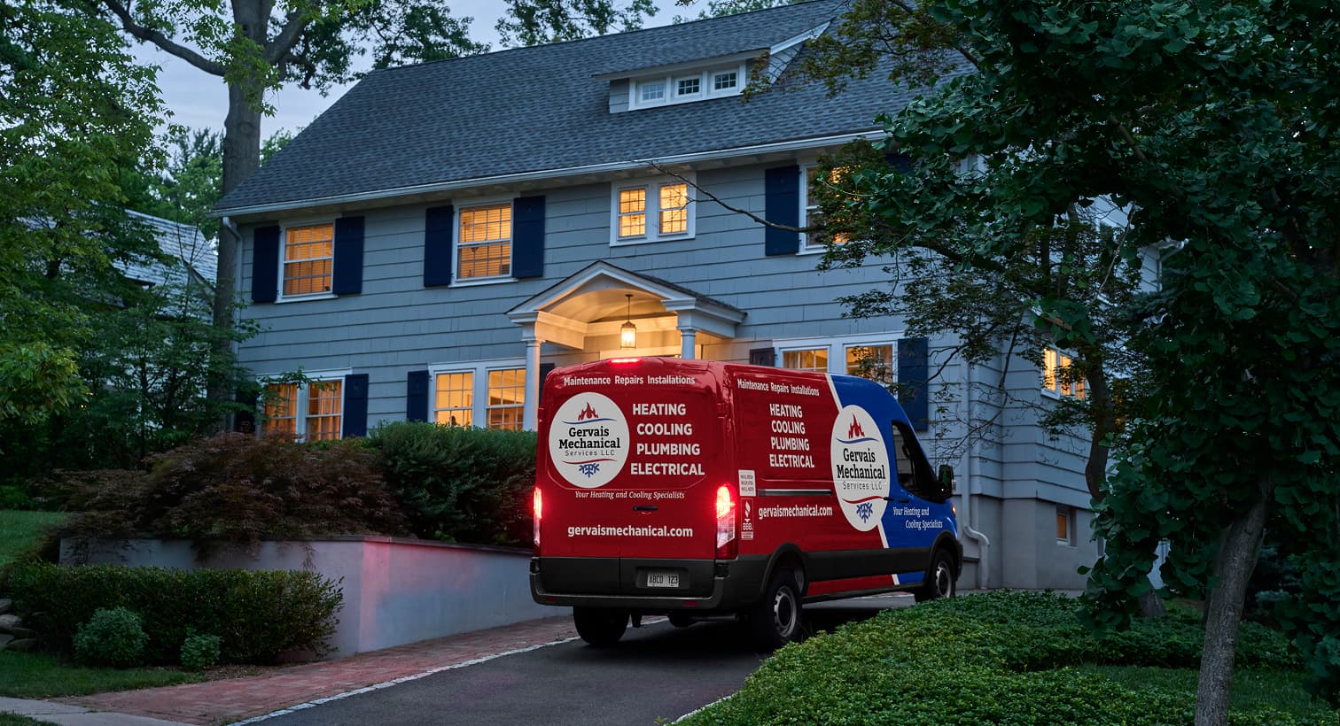 A Gervais service van parked in a residential driveway at night, arriving to provide 24/7 emergency heating repair services.