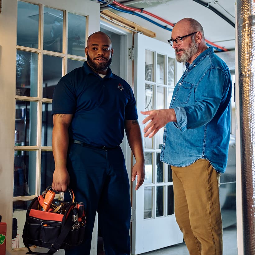 A Gervais technician discusses the repair and installation services with a homeowner.