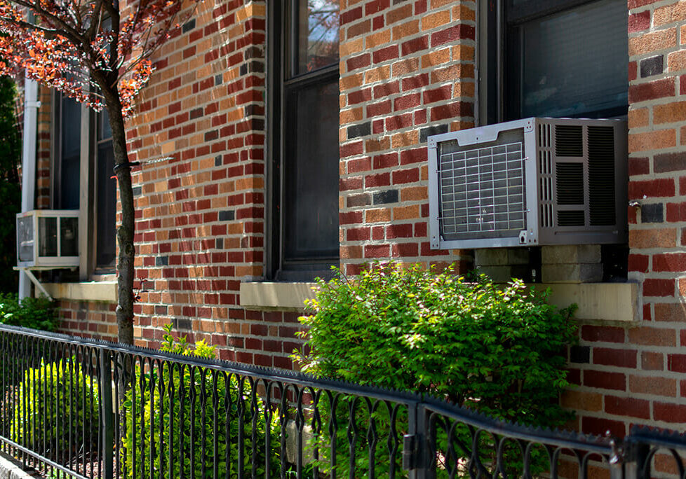 Window air conditioning units in use in windows