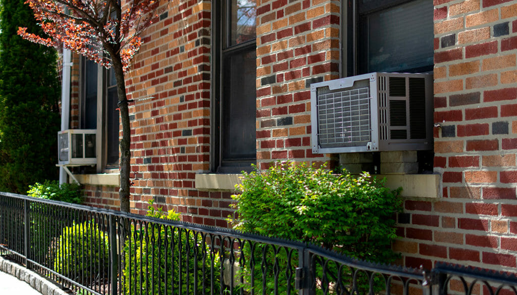 Window air conditioning units in use in windows