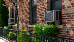 Window air conditioning units in use in windows